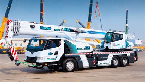 Side view of white painted truck crane with turquoise accents and prominent EV lettering